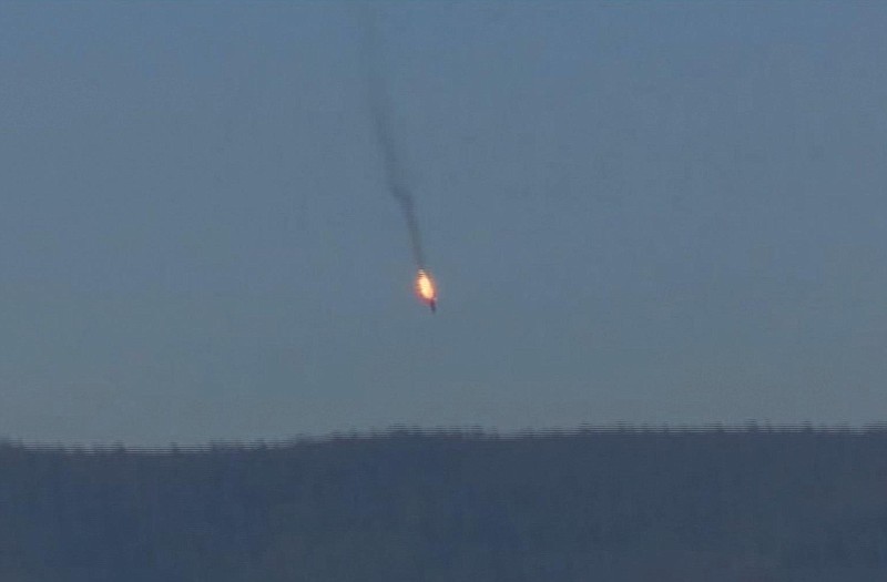This frame grab from video by Haberturk TV, shows a Russian warplane on fire Tuesday before crashing on a hill as seen from Hatay province. Turkey shot down the Russian warplane Tuesday, claiming it had violated Turkish airspace and ignored repeated warnings. Russia denied that the plane crossed the Syrian border into Turkish skies. 