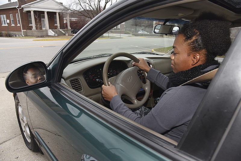 Briana Gray is ready to drive away in the new-to-her car, received Wednesday from Working Wheels for Working Families.