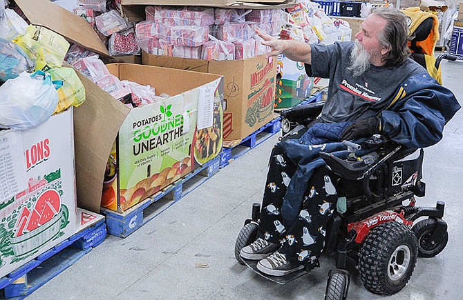 Cargill Cares
Food Pantry
ordering and
distribution manager
Max Wachter
discusses
the sorted food
items, which will
benefit about
350 Moniteau
County families,
or approximately
1,000 people,
this month.