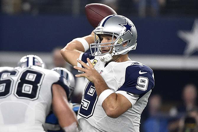 Dallas Cowboys quarterback Tony Romo (9) throws a pass in the first half of an NFL football game against the Carolina Panthers, Thursday, Nov. 26, 2015, in Arlington, Texas.