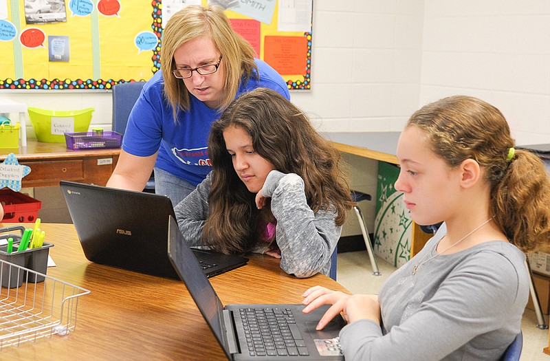 Joanna Olmedo receives help from California Middle School English teacher Heather Schoeneberg as Brylie Smith works independently using the 1:1 Chromebooks provided to the English and Science classrooms this school year.