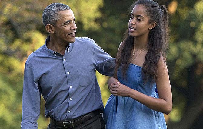 President Barack Obama and his daughter Malia walk earlier this year across the South Lawn of the White House in Washington from Marine One. The 17-year-old is among the millions of U.S. high school seniors preparing to enter college.