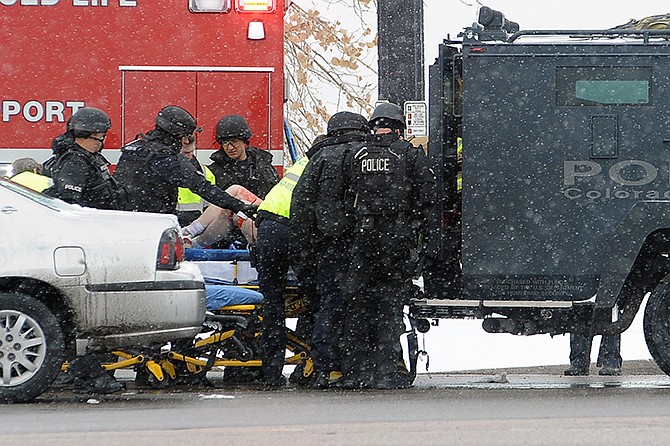 A person is transported to an ambulance Friday in Colorado Springs, Colorado. A gunman opened fire at a Planned Parenthood clinic on Friday, authorities said, wounding multiple people.