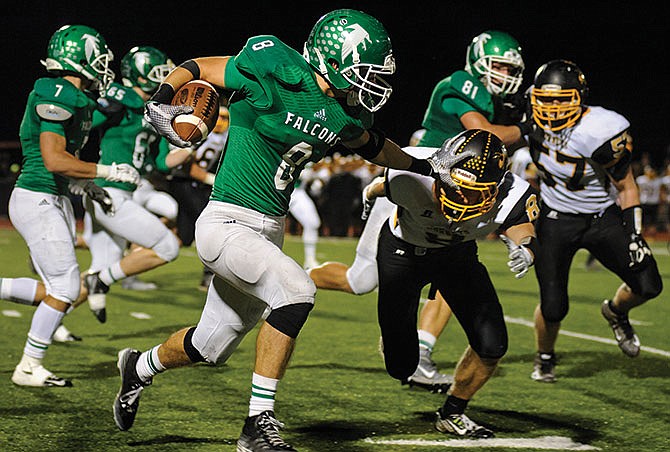 Blair Oaks wide receiver Adam Schell (carrying ball above) was among area football players named to All-Central District teams selected by members of the Missouri Sportswriters and Sportscasters Association.