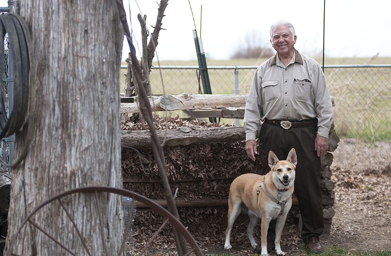 Cliff Keeler stands with his American dingo, Shonkay