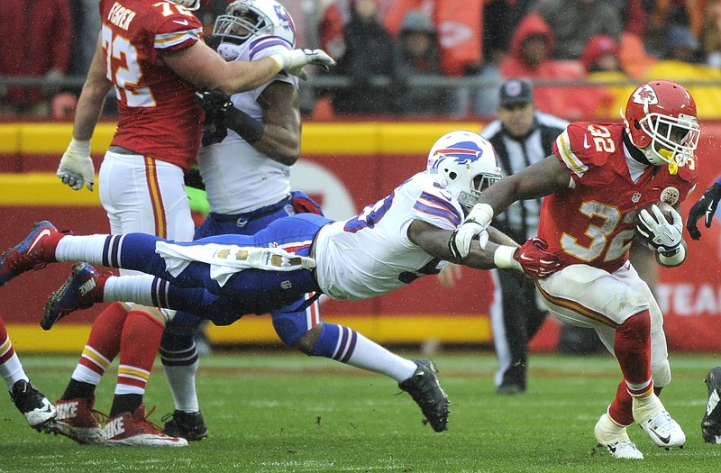 Chiefs running back Spencer Ware runs past a tackle attempt by Bills linebacker Nigel Bradham during the first half of Sunday afternoon's game at Arrowhead Stadium.