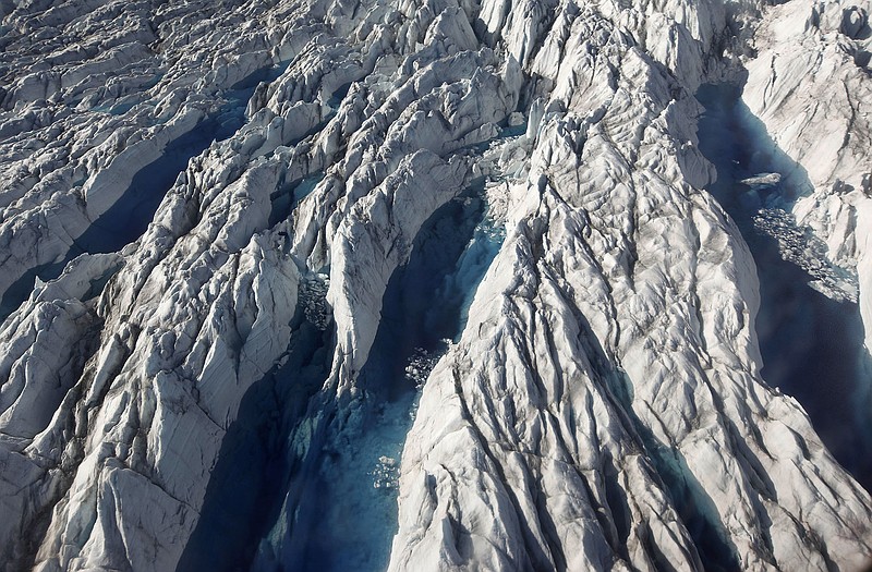 This 2011 photo shows pools of melted ice form atop Jakobshavn Glacier, near the edge of the vast Greenland ice sheet. 