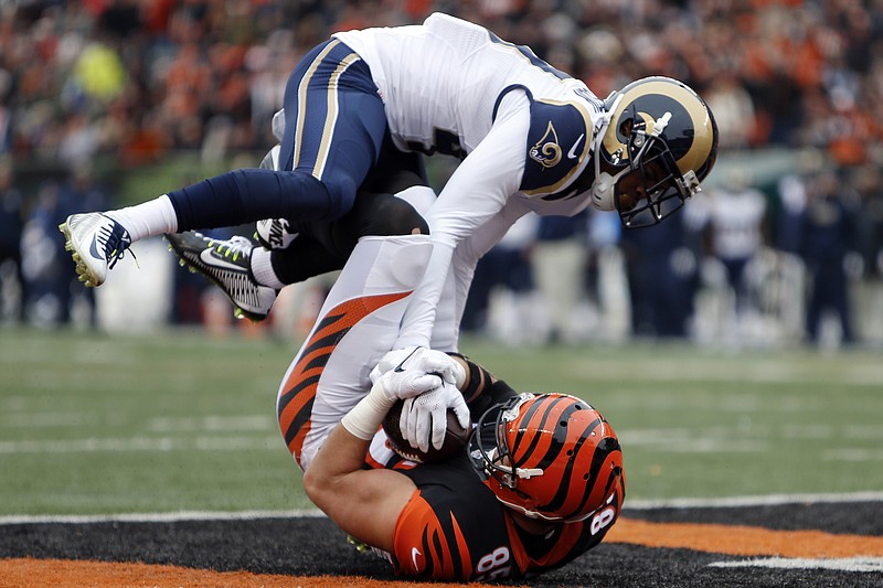Bengals tight end Tyler Eifert scores a touchdown against the defense of Rams cornerback Marcus Roberson in the first half of Sunday's game in Cincinnati.