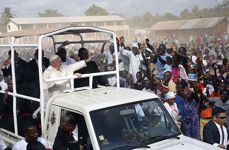 Pope Francis waves to the crowd during his visit to the Central Mosque in a Moslem enclave in the Central African Republic on Monday.