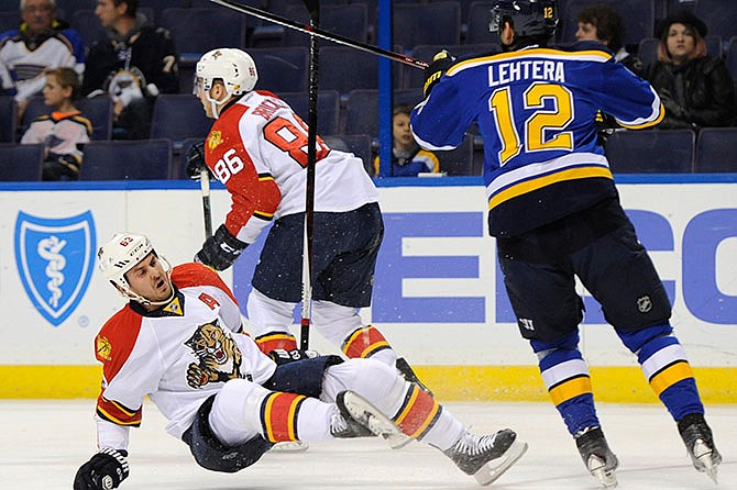 St. Louis Blues' Jori Lehtera (12) checks Florida Panthers' Dave Bolland (63) as Panthers' Connor Brickley (86) skates away during the first period of an NHL hockey game Tuesday, Dec. 1, 2015, in St. Louis.