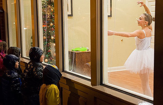 A group of children look in the window of Bandre Hunt & Snider, LLC as a young ballerina performs
inside during the 2014 Living Windows event in downtown Jefferson City. Living Windows will take place in downtown Jefferson City from 6-9 p.m. Dec. 6.