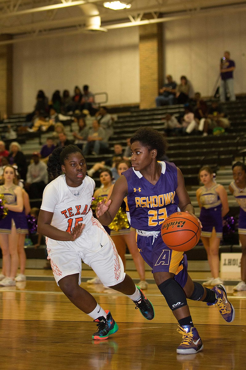 Ashdown's Cambry McCullough drives past Texas High's Mia Wilson Tuesday night, Dec. 8, 2015, during a game at Texas High.