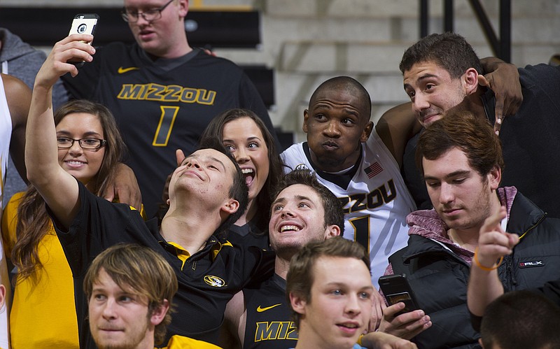 Missouri's Terrence Phillips (right) poses for a selfie in the stands with fans after Wednesday night's 85-78 win against Omaha at Mizzou Arena.
