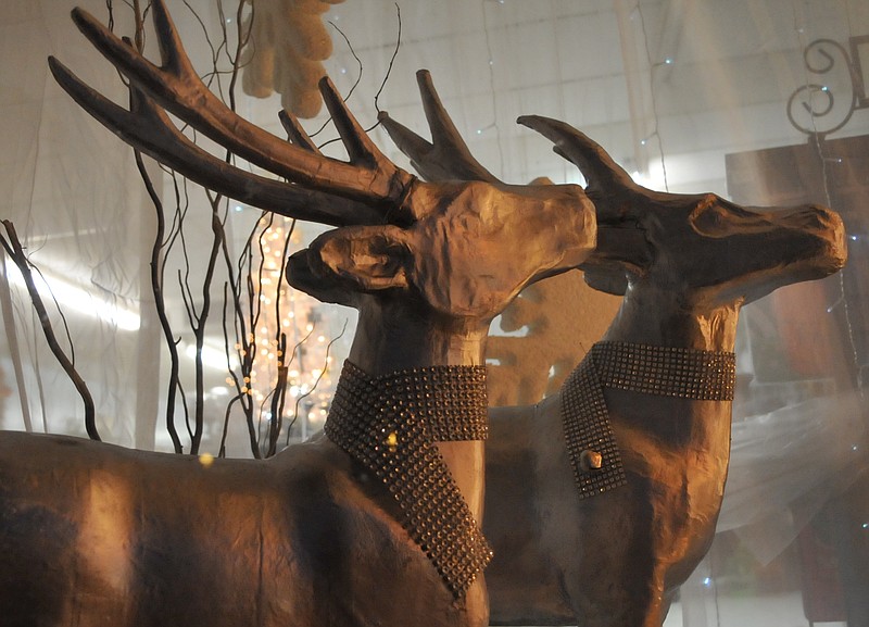 These two decorated reindeer in a Hughes Springs floral shop are painted gold with shiny necklaces.