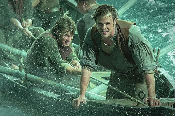 This photo provided by Warner Bros. Pictures shows, Chris Hemsworth, right, as Owen Chase, and Sam Keeley as Ramsdell, left, in a scene from the film, "In the Heart of the Sea." 