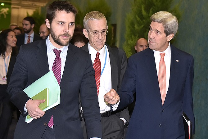 U.S. Secretary of State John Kerry, right, walks with White House senior advisor Brian Deese, left, and U.S. Special Envoy for Climate Change Todd Stern, center, to attend a meeting with French Foreign Minister Laurent Fabius during the COP 21 United Nations conference on climate change at Le Bourget, on the outskirts of Paris.