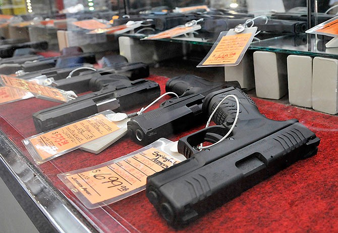 Pistols are seen for sale at Jefferson Armory inside of House of Bargains in Apache Flats, west of Jefferson City. In addition to guns and ammo sales, Jefferson Armory serves as a delivery point to individuals who purchase guns online.