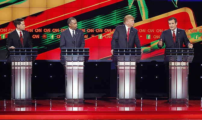 Ted Cruz, right, speaks as Marco Rubio, left, Ben Carson and Donald Trump watch during the CNN Republican presidential debate at the Venetian Hotel & Casino on Tuesday in Las Vegas.