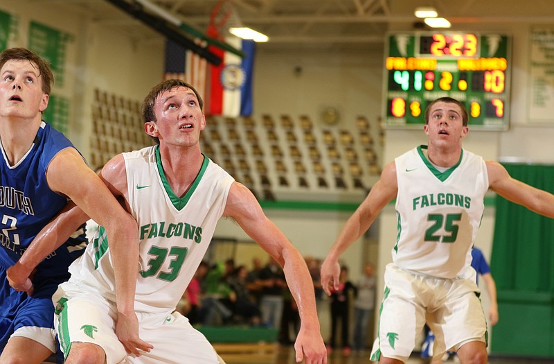 Garrett Kliethermes (33) and Kaden Helsel of South Callaway look up at a potential rebound along with C.J. Closser of the Falcons (25) during Tuesday night's game in Wardsville.