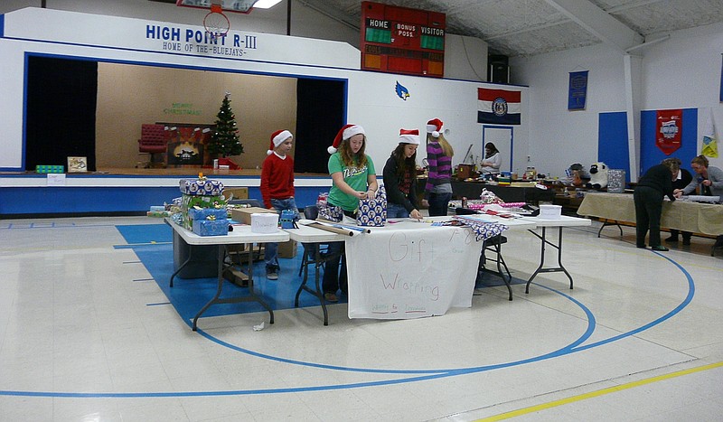 High Point seventh and eighth graders manned the gift wrapping booth Saturday, Dec. 5. Students wrapped any and all presents brought to them for a donation for the class trip.