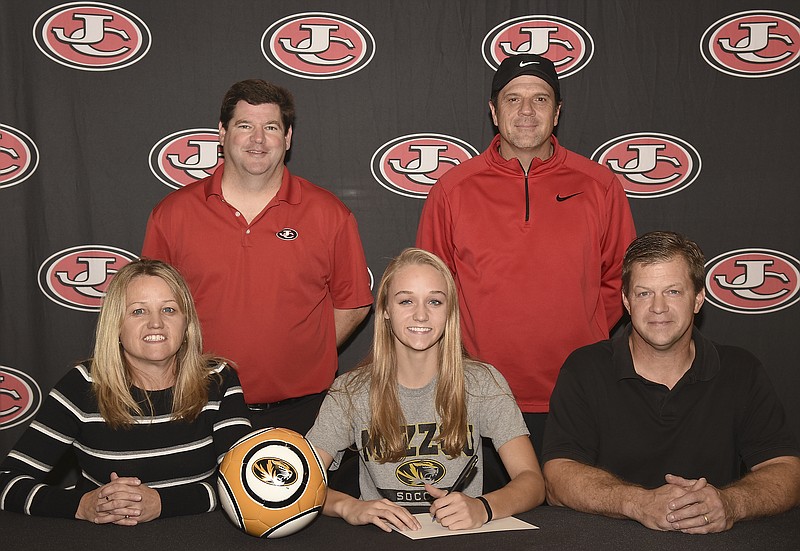 Sarah Luebbert (seated center) of Jefferson City High School has signed a letter of intent to play soccer at the University of Missouri. Also seated are her parents, Dianne and Jerry Luebberg. Standing (from left) are Jefferson City assistant coach Rick Hirst and head coach Eddie Horn.