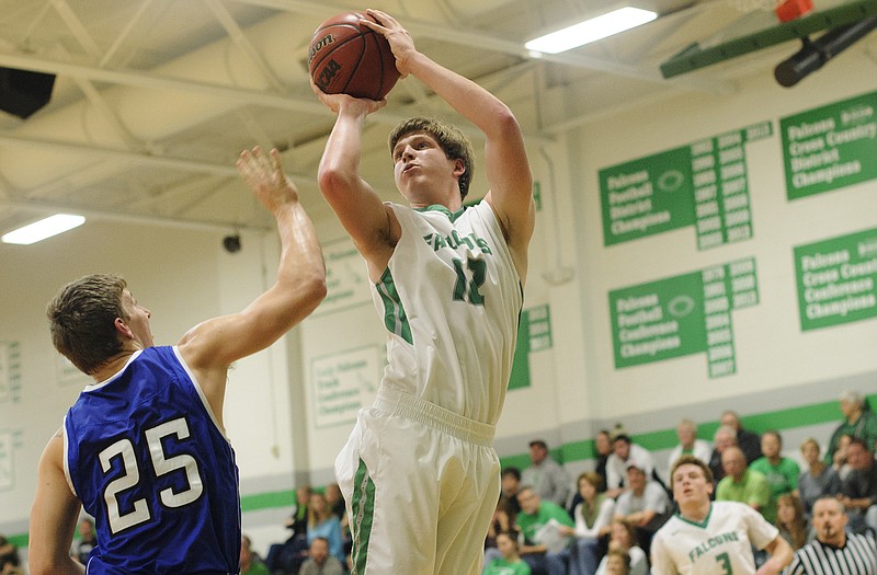 Blair Oaks' Jason Rackers puts up a baseline fade away jump shot over Hermann's Mat Hug in the first half of Monday night's game in Wardsville.