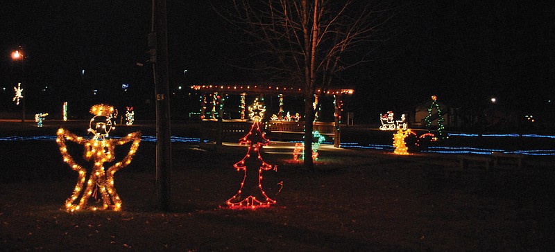 A rapidly flashing set of blue lights gives the illusion of running water through the park among the many lighted holiday displays at the Unity Circle of Lights in Versailles.