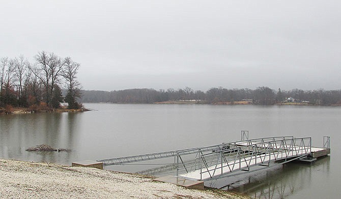 Rain drizzles down on a gray Little Dixie Lake in Millersburg. The lake is just one of several locations where the Missouri Department of Conservation creates fish habitats from natural, recycled Christmas trees.