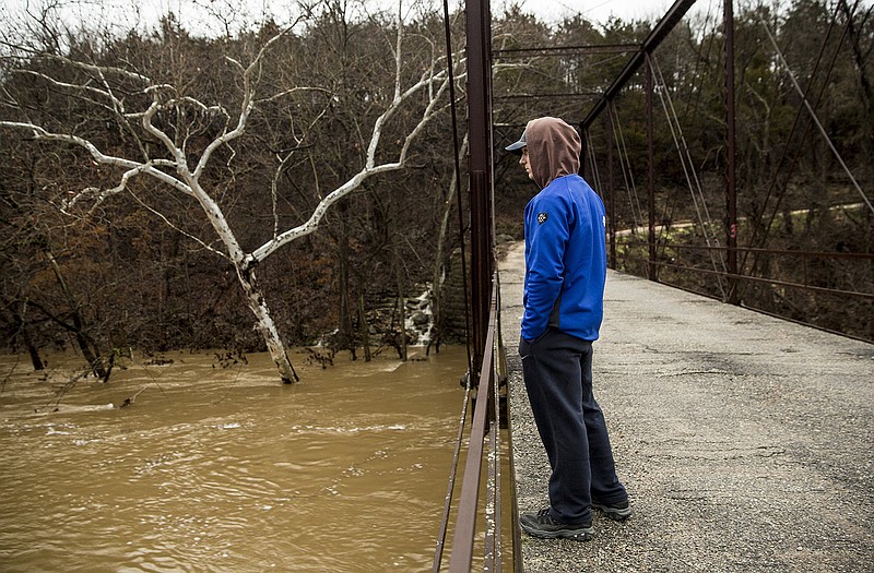 Westphalia resident Spencer Bexten peers into a flooded Maries River Monday morning just north of Westphalia on County Route 611. Bexten didn't make it to the bridge over the weekend, but heard that at its peak, the water had made it to the bottom of the bridge.