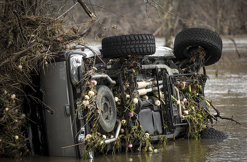 A vehicle discovered Tuesday morning sits near a turnip field along Loesch Road after floodwaters of the Moreau River receded from the area. The Missouri Highway Patrol has confirmed the driver was able to escape two days ago when he lost control of the truck in high water.