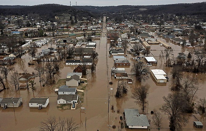 This photo shows a northern view of 1st Street where homes were flooded on Tuesday, Dec. 29, 2015, in Pacific, Mo. Torrential rains over the past several days pushed already swollen rivers and streams to virtually unheard-of heights in parts of Missouri and Illinois. (J.B. Forbes /St. Louis Post-Dispatch via AP)