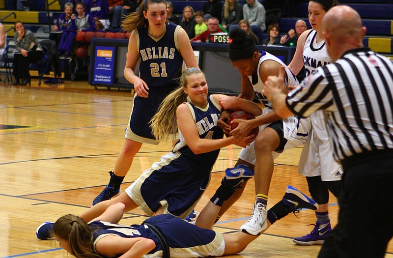 Luci Francka of Helias fights for a loose ball during Tuesday night's game against Hickman in the semifinals of the State Farm Holiday Hoops Invitational at Rackers Fieldhouse.