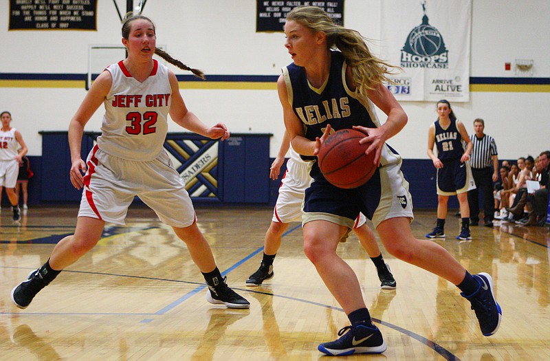 Morgan Wieberg of Helias drives against Jefferson City's Megan Foster on Wednesday in the third-place game of the Holiday Hoops Invitational at Rackers Fieldhouse.