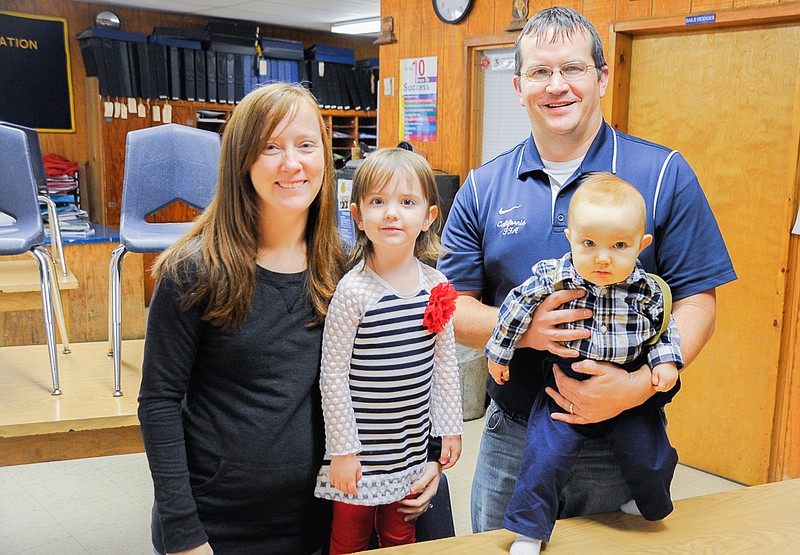 2015 Moniteau County Baby Will Bieri stands with his family - mother Tracey, sister Hadley and father Adam - in his father's agriculture classroom at California High School.