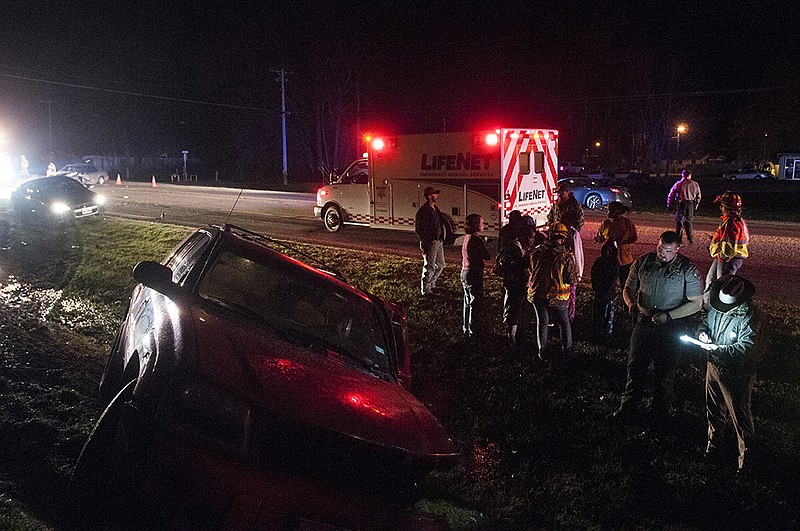 First responders work the scene of a head-on collision between a red SUV and a silver Honda car Wednesday night on U.S Highway 67. No serious injuries were sustained in the accident. 