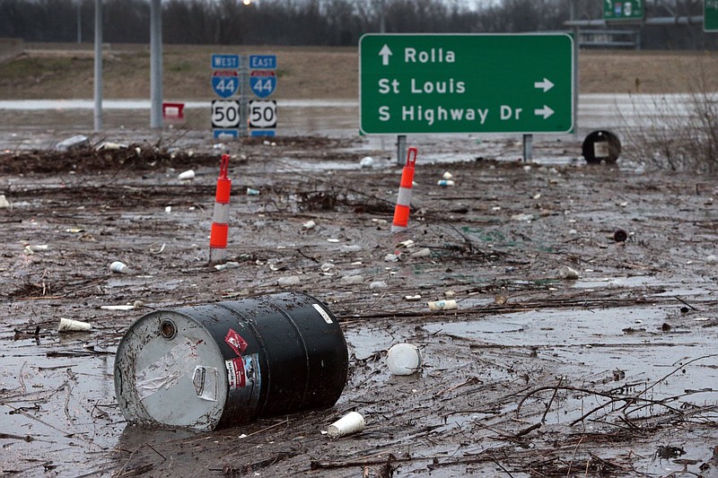 A barrel from an auto store floats on Highway 141, south of the Interstate 44 entrance ramp in Fenton, a suburb of St. Louis on Wednesday, Dec. 30, 2015. (Robert Cohen/St. Louis Post-Dispatch via AP) 