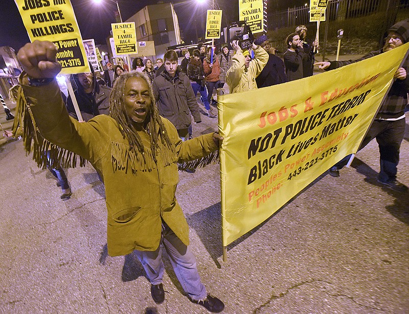 Lee Patterson, left, joins demonstrators Tuesday in Baltimore in protest of recent police shootings, including a grand jury's decision not to indict two white Cleveland police officers in the fatal shooting of Tamir Rice, a black 12-year-old boy who was playing with a pellet gun. 