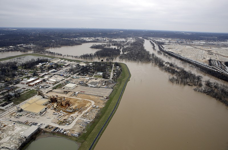In this aerial photo, a levee holds back flood water from the Meramec River keeping a section of Valley Park dry.