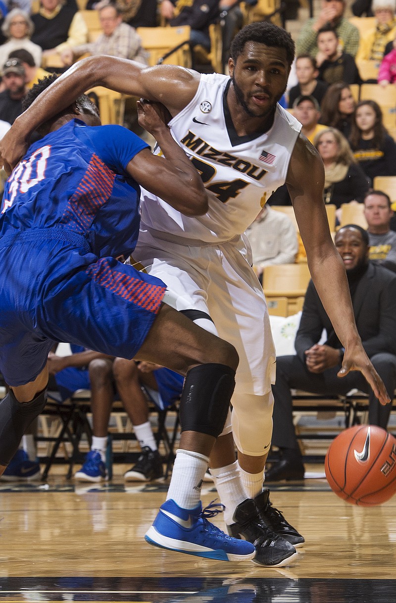 Missouri's Kevin Puryear, shown working his way around Savannah State's Teslim Idris during Saturday's game in Columbia, and the rest of the Tigers open conference play today at Georgia.