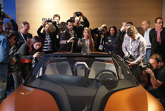 People take pictures of the BMW i Vision Future Interaction concept car Tuesday during a news conference at CES Press Day at CES International in Las Vegas.