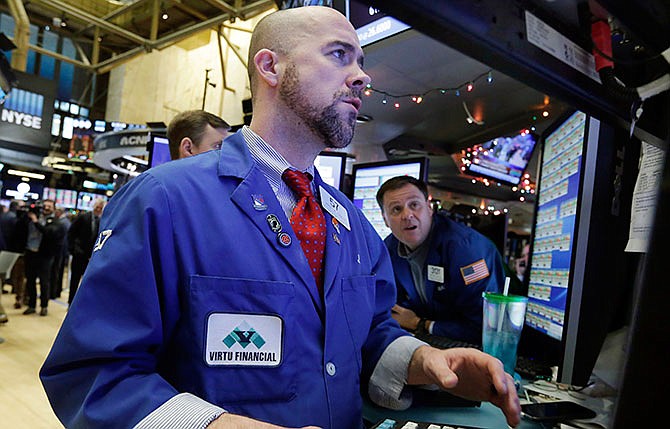 Specialist Jarret Johnson, foreground, works on the floor of the New York Stock Exchange, Thursday, Jan. 7, 2016. U.S. stocks are opening sharply lower as worries intensify about China's economy and dropping oil prices. 