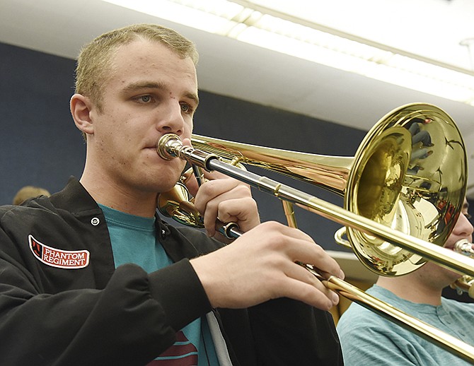 Max Mollenkamp plays the trombone during Friday's instrument music class at Jefferson City High School.