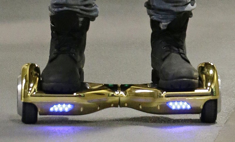 In this Oct. 5, 2015 file photo, Seattle Seahawks wide receiver B.J. Daniels rides through a hallway at CenturyLink Field on an electric self-balancing scooter commonly called a "hoverboard," as he arrives for an NFL football game against the Detroit Lions in Seattle. Since December 2015, several universities have banned or limited hoverboards on their campuses, saying the two-wheeled, motorized scooters are unsafe. Beyond the risk of falls and collisions, colleges are citing warnings from federal authorities that some of the self-balancing gadgets have caught on fire.