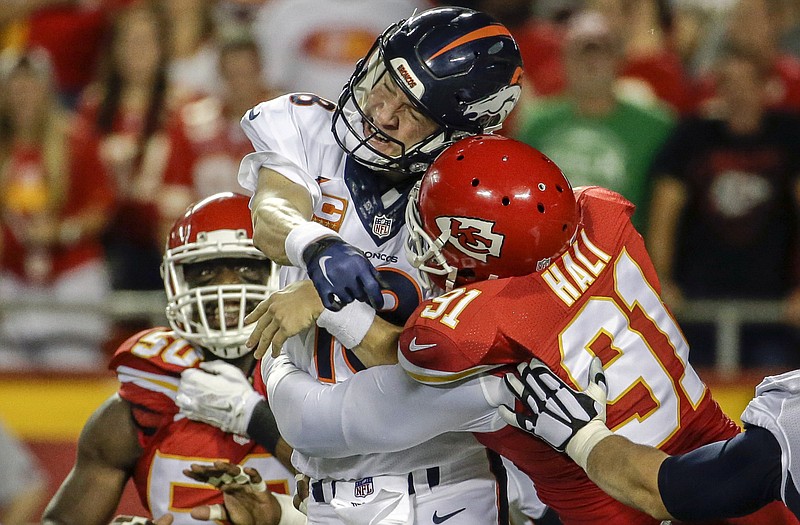Chiefs linebacker Tamba Hali hits Broncos quarterback Peyton Manning during a game this season at Arrowhead Stadium.