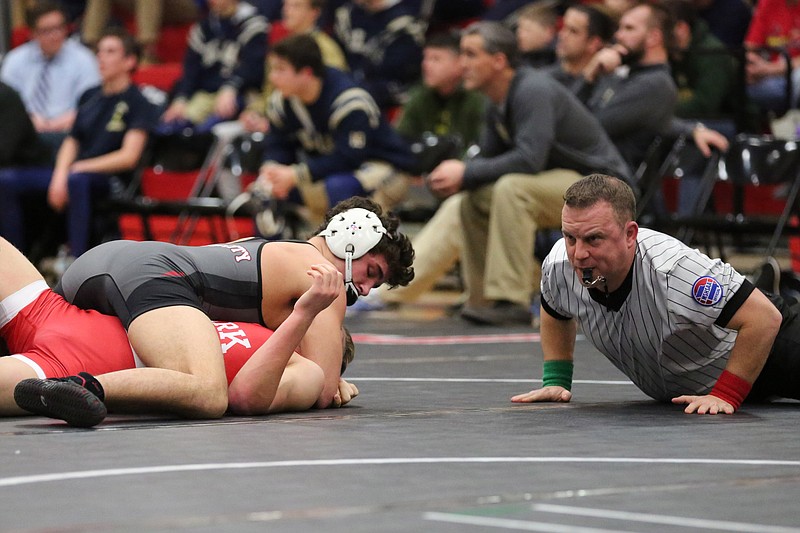 Tanner Irwin of the Jays closes in on a win by fall during his match against Ozark on Friday night at Fleming Fieldhouse.