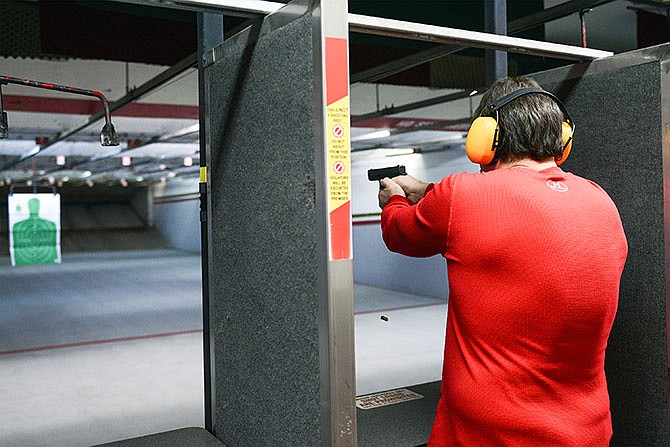 Bill Caisee, of Eldon, fires two rounds from his Glock 19 pistol at a target in the distance at Ammo Alley. "It relieves tension," said Caisee, "I do two things to relieve stress - shoot and lift weights." Caisee agrees with having background checks for those who purchase firearms. "I think background checks for everybody is a good thing. It's not taking everyone's right away from owning a firearm."