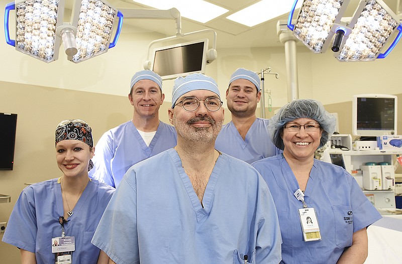 Dr. Blake Rodgers, middle, poses in a St. Mary's Hospital operating room with his SSM spine team. Pictured with Rodgers are, from left, Jessie Troesser, Ed Gerber, Eric Bailey and Rose Nelson.
