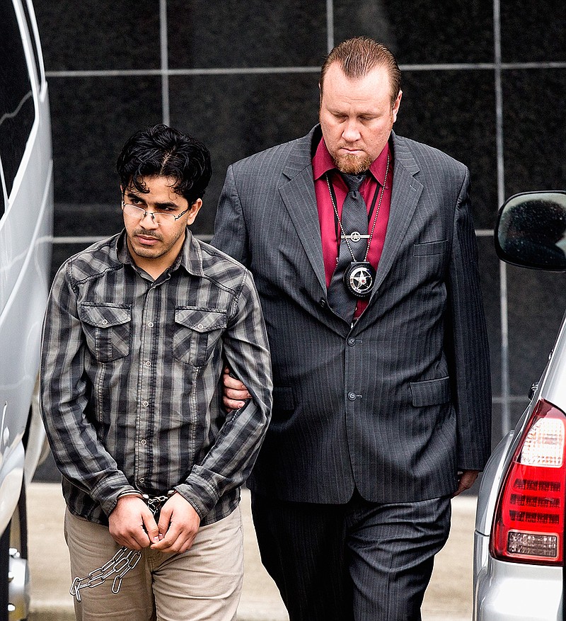 In this Jan. 8, 2016 file photo, Omar Faraj Saeed Al Hardan, left, is escorted by U.S. Marshals from the Bob Casey Federal Courthouse, in Houston. Al Hardan, who came to Houston from Iraq in 2009 is set to be arraigned Wednesday, Jan. 13, 2015, and have a bond hearing after his arrest on charges he tried to help the Islamic State group. 