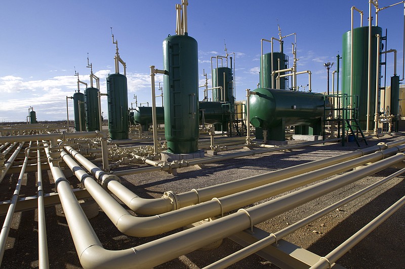 This Wednesday, Dec. 16, 2015, photo shows new tank battery near four horizontal wells at Pioneer Natural Resources in Big Lake, Texas. Residents of the West Texas town say it is time for the city to diversify its economy and wean off oil.