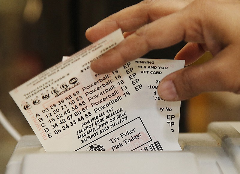 Momtaz Parvin pulls Powerball lottery tickets from the printer at her store in Oklahoma City, Friday, Jan. 8, 2016, as the multi-state jackpot reaches $800 million. With ticket sales doubling previous records, the odds are growing that someone will win Saturday's record jackpot, but if no one wins the top prize, next week's drawing is expected to soar past $1 billion. 